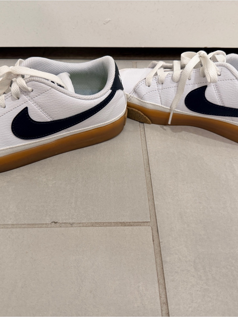 Nike women’s White Leather Sneakers with Navy Swoosh and Gum Sole